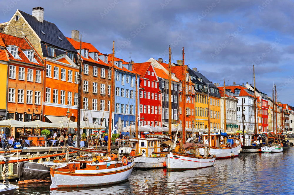 Colorful Nyhavn houses and wooden sailboats along the canal